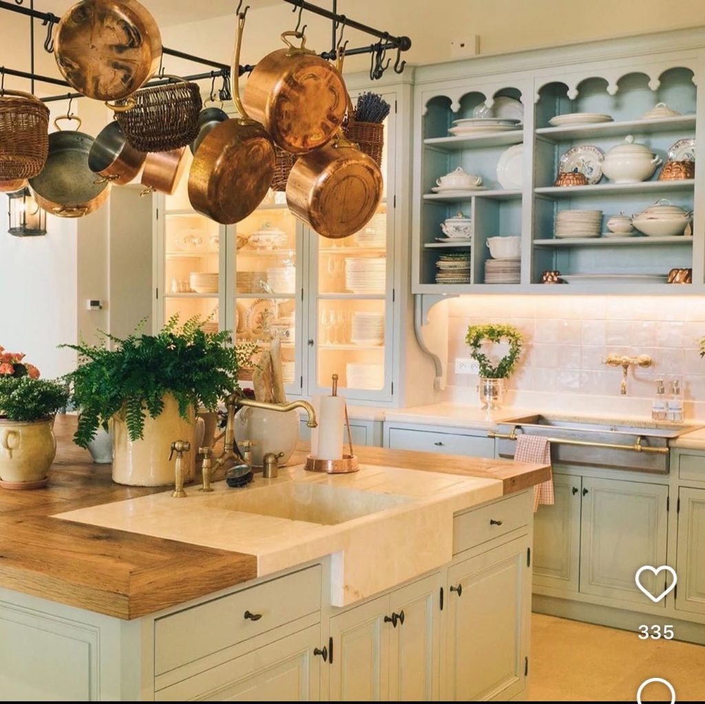 Copper pots on a display in a french country kitchen