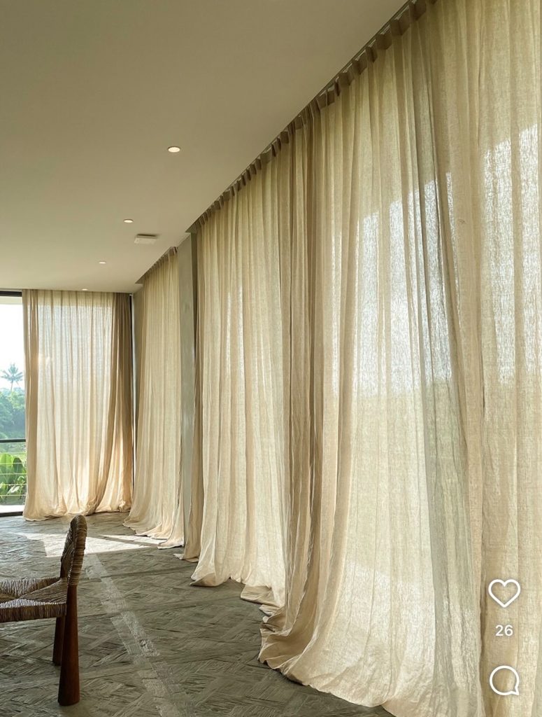 French country bedroom with a flowing linen curtains
