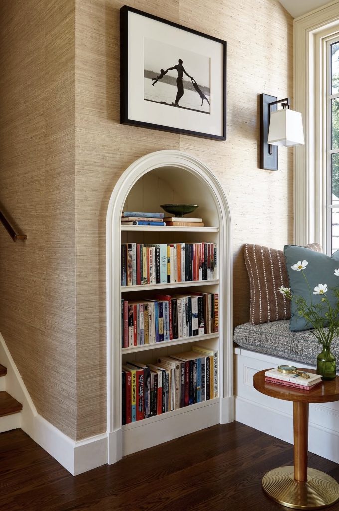 Bookshelf in a bay window reading nook