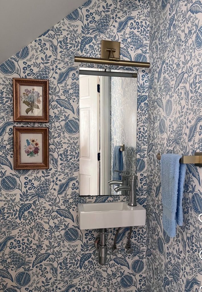 Bold Wallpaper In Tiny Half Bathroom Under Stairs