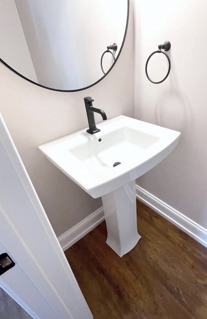 Pedestal bathroom sink with matte faucet 