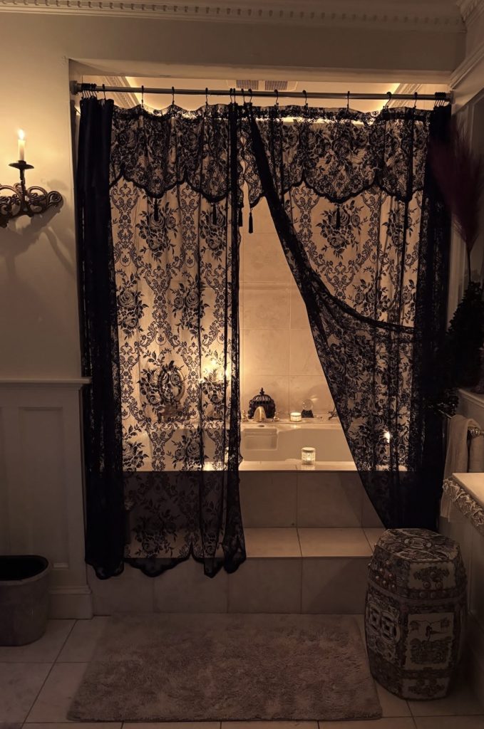 Heavy curtains in dark academia bathroom 