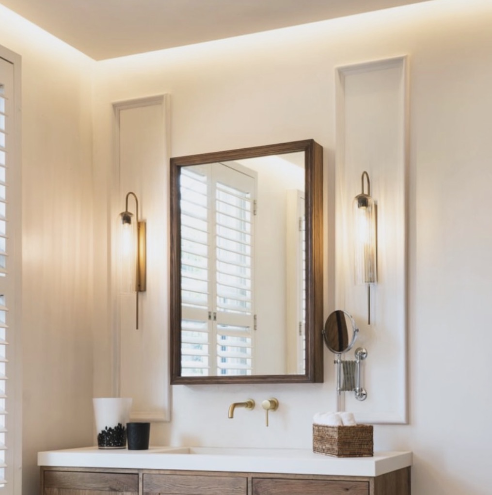 Statement mirror in a warm neutral bathroom
