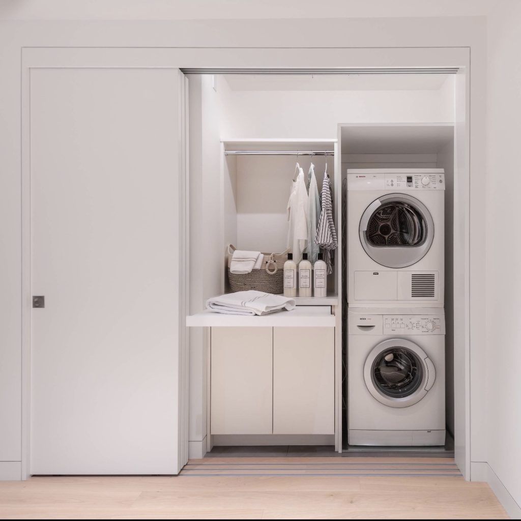 Laundry Appliances Behind Sleek Sliding Doors